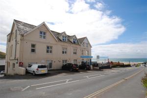 a building on the side of a road with cars parked at 1 Bed in Woolacombe oc-seablu in Woolacombe