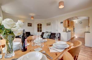 a dining room and living room with a wooden table at Golden Beach in Woolacombe
