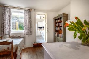 a living room with a table and a large window at Seaview Cottage in Mortehoe