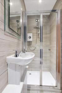 a bathroom with a sink and a shower at Nigel House in Mousehole