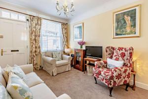 a living room with a couch and chairs and a tv at Crown Cottage - Rye in Rye
