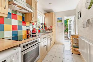 a kitchen with colorful tiles on the wall at Crown Cottage - Rye in Rye