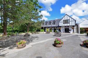 a building with benches and flowers in front of it at 2 Bed in Penzance oc-pc467 in Gulval