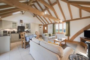 a living room with a couch and a table in a room at The Old Cowshed in Stone