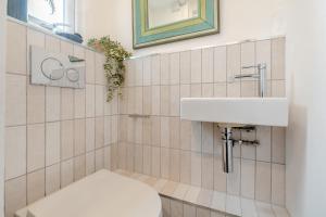 a bathroom with a toilet and a sink at Shell Cottage 10 St Peters Street in St Ives +13 photos