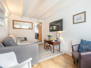 a living room with a couch and a table at Shell Cottage 10 St Peters Street in St Ives