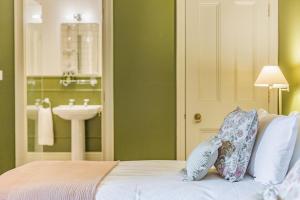 a bedroom with a sink and a bed with two pillows at Sir Henry Sidney - Ludlow Castle in Ludlow +16 photos