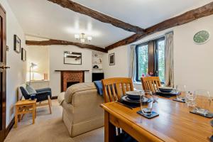 a living room with a table and a couch at Rosie Cottage in Bassenthwaite