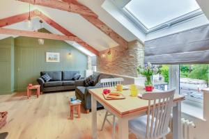 a kitchen and living room with a table and chairs at Rolling Hills in Woolacombe