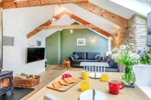 a living room with a table and a fireplace at Rolling Hills in Woolacombe +10 photos