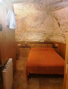 a small bedroom with a bed in a room at Cueva a 10 min de Albacete in Chinchilla de Monte Aragón