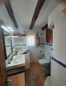 a bathroom with a sink and a toilet at Cueva a 10 min de Albacete in Chinchilla de Monte Aragón