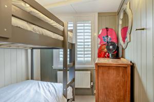 a small bedroom with a bunk bed and a desk at Trehawn Cottage in Saint Columb Major