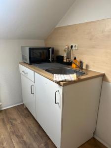 a kitchen with a microwave and a sink at Ferienwohnung in Korbach in Korbach +12 photos