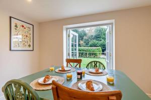 a dining room with a table with food on it at Hall Cottage in Eccleshall +13 photos
