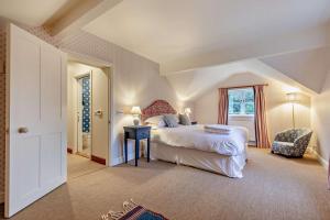 a bedroom with a large bed and a window at Hall Cottage in Eccleshall