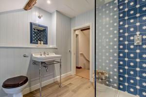 a bathroom with a sink and a toilet at Hall Cottage in Eccleshall