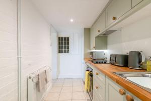 a kitchen with a sink and a counter top at Laurel Cottage - The Retreat in Malvern Wells +13 photos