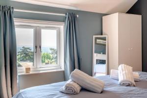 a bedroom with a bed with pillows and a window at Laurel Cottage - The Retreat in Malvern Wells