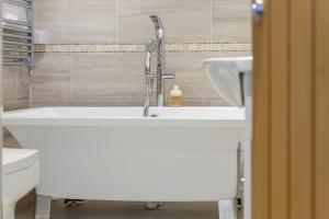 a bathroom with a sink and a toilet at River Watch - Fowey in Fowey +18 photos
