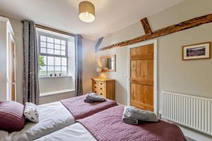 a bedroom with a large bed and a window at Parlwr Mawr in Dyffryn