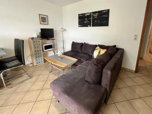 a living room with a couch and a table at Malerisches Ferienhaus in Reil in Reil +22 photos
