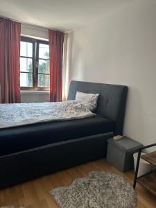 a bedroom with a bed and a window and a rug at Private Wohnung im Herzen Kölns in Cologne