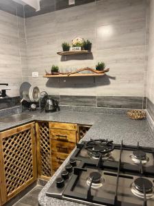 a kitchen with a stove and a counter top at Ge boho house in Dahab