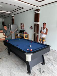two men playing a game of pool in a room at European Hostel Central Pattaya in Pattaya +14 photos