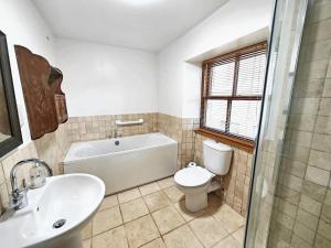 a bathroom with a tub and a toilet and a sink at Low Moor Farm in Cotterdale +9 photos