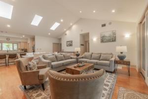 a large living room with couches and a table at Ultimate Hill Country Retreat, POOL, Creek, Sleeps 10 in Dripping Springs