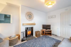 a living room with a couch and a fireplace at Bryn Penmaen in Pwllheli