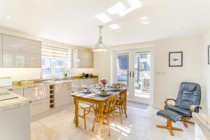 a kitchen with a table and chairs in a room at The Hatchery in Legbourne +17 photos