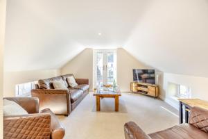 a living room with a couch and a table at The Hatchery in Legbourne