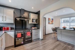 a kitchen with stainless steel appliances and a counter at Orchard House - Cockermouth in Embleton