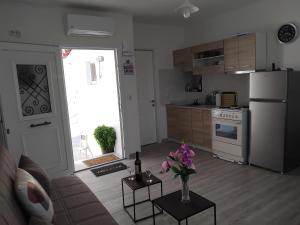 a kitchen with a vase of flowers on a table at Rania's Seaview Corner in Samos