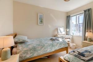a bedroom with two twin beds and a window at Bwythyn Y Mor - Broad Haven in Broad Haven