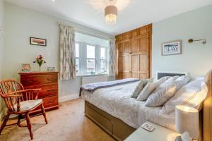 a bedroom with a bed and a desk and a chair at The Dyers Retreat - Halifax in Sowerby Bridge