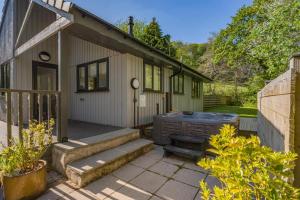 una pequeña casa con una parrilla en el patio en Heather - Bude, en Bude