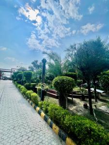 a cobblestone street with trees and a bridge at ZenRoofs- 02 Studio Apartment in Vrindāvan