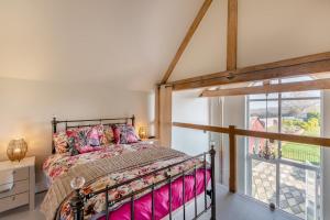 a bedroom with a bed and a window at The Lodge - Hallmark House in Saint Michaels
