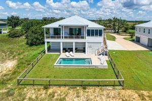 an aerial view of a house with a swimming pool at Luxury Beachfront Living! Epic Ocean Springs Home in Ocean Springs
