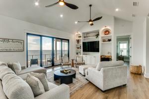 a living room with white furniture and a view of the ocean at Luxury Beachfront Living! Epic Ocean Springs Home in Ocean Springs