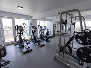 a gym with several tread machines in a room at Apartament Lara mamaia in Mamaia Sat/Năvodari