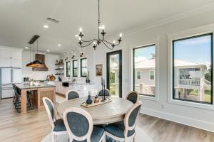a kitchen and dining room with a table and chairs at Luxury Beachfront Living! Epic Ocean Springs Home in Ocean Springs