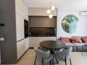 a living room with a table and chairs and a couch at Apartament Lara mamaia in Mamaia Nord