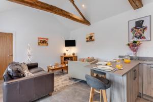 a living room with a couch and a table at Two Hoots Cottage in Gilsland