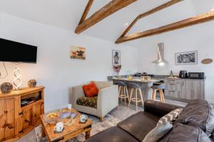 a living room with a couch and a table at Two Hoots Cottage in Gilsland
