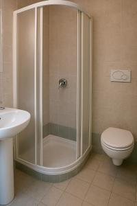 a bathroom with a shower with a toilet and a sink at Baita Cao Como Lake in Brunate +16 photos