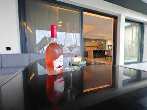 a bottle of wine sitting on a counter with a wine glass at KarLa in Otopeni